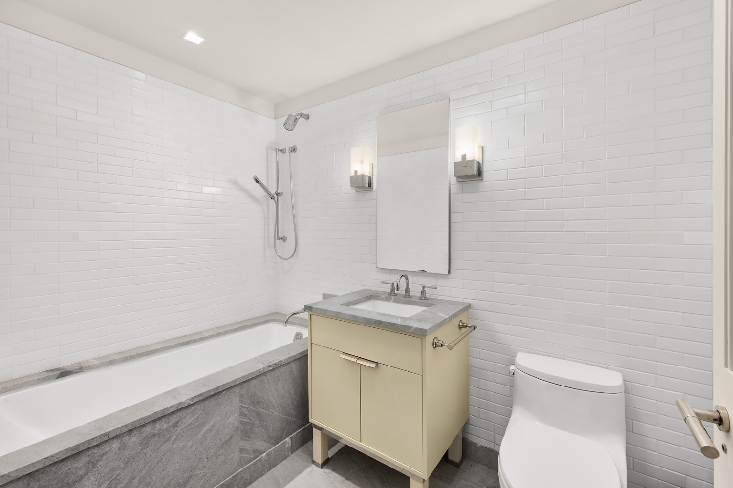 150 Charles Street, Unit 2ES Manhattan, NY 10014 - Photo 4 of 12 a bathroom with a granite countertop sink toilet and shower