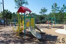 a view of a park with swings and slides