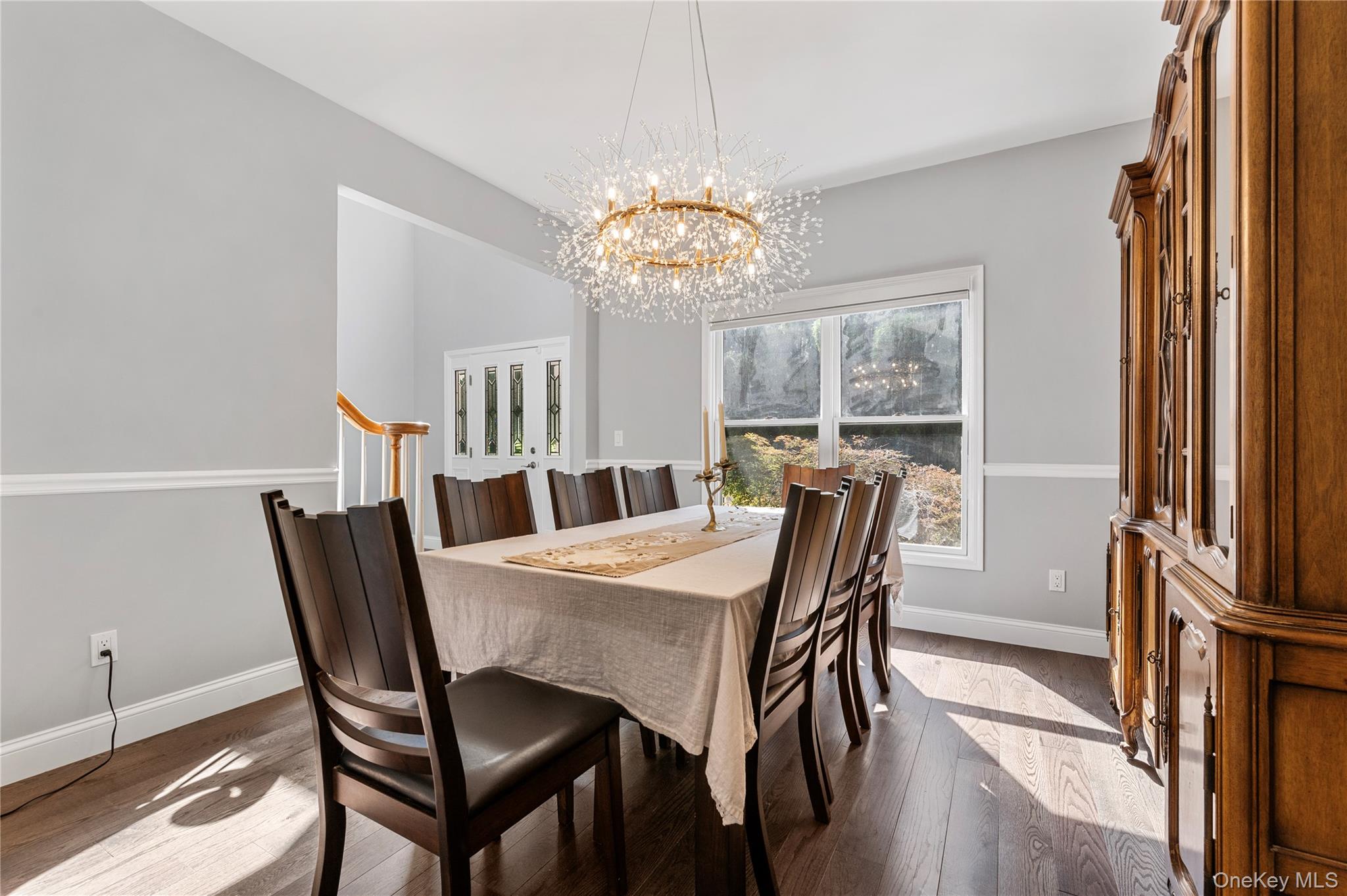 91 Bennetts Road East Setauket, NY 11733 - Photo 11 of 31 Dining room with a chandelier and dark wood-style floors