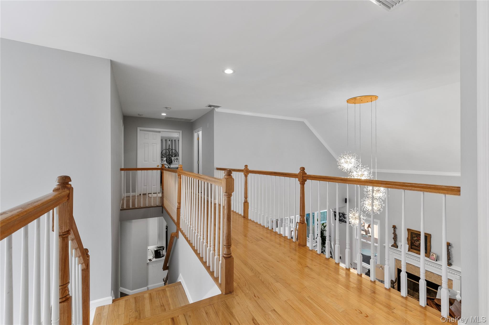 91 Bennetts Road East Setauket, NY 11733 - Photo 14 of 31 Corridor with an upstairs landing, wood finished floors, and recessed lighting