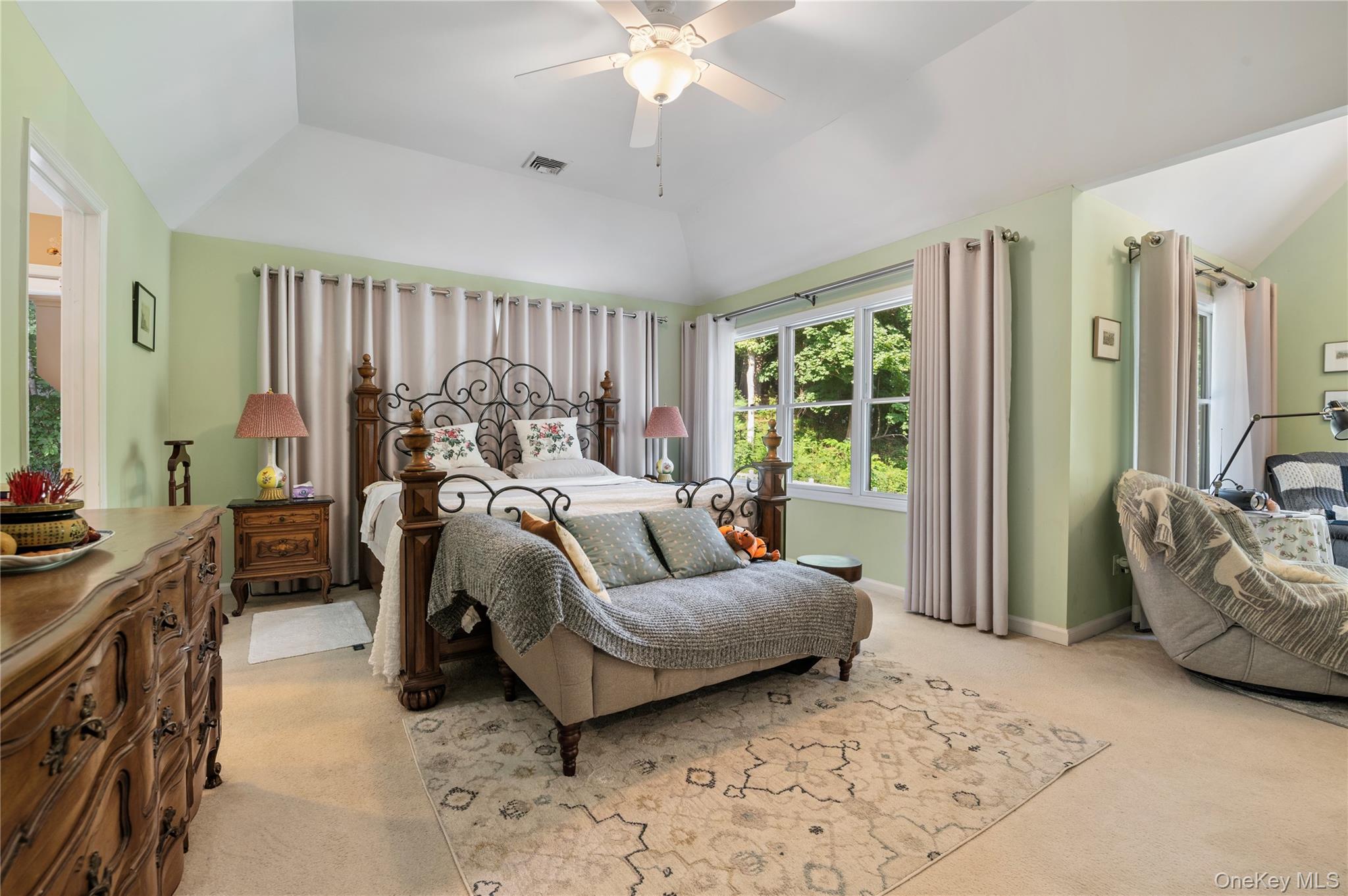 91 Bennetts Road East Setauket, NY 11733 - Photo 15 of 31 Master Bedroom featuring light colored carpet, vaulted ceiling, and a ceiling fan