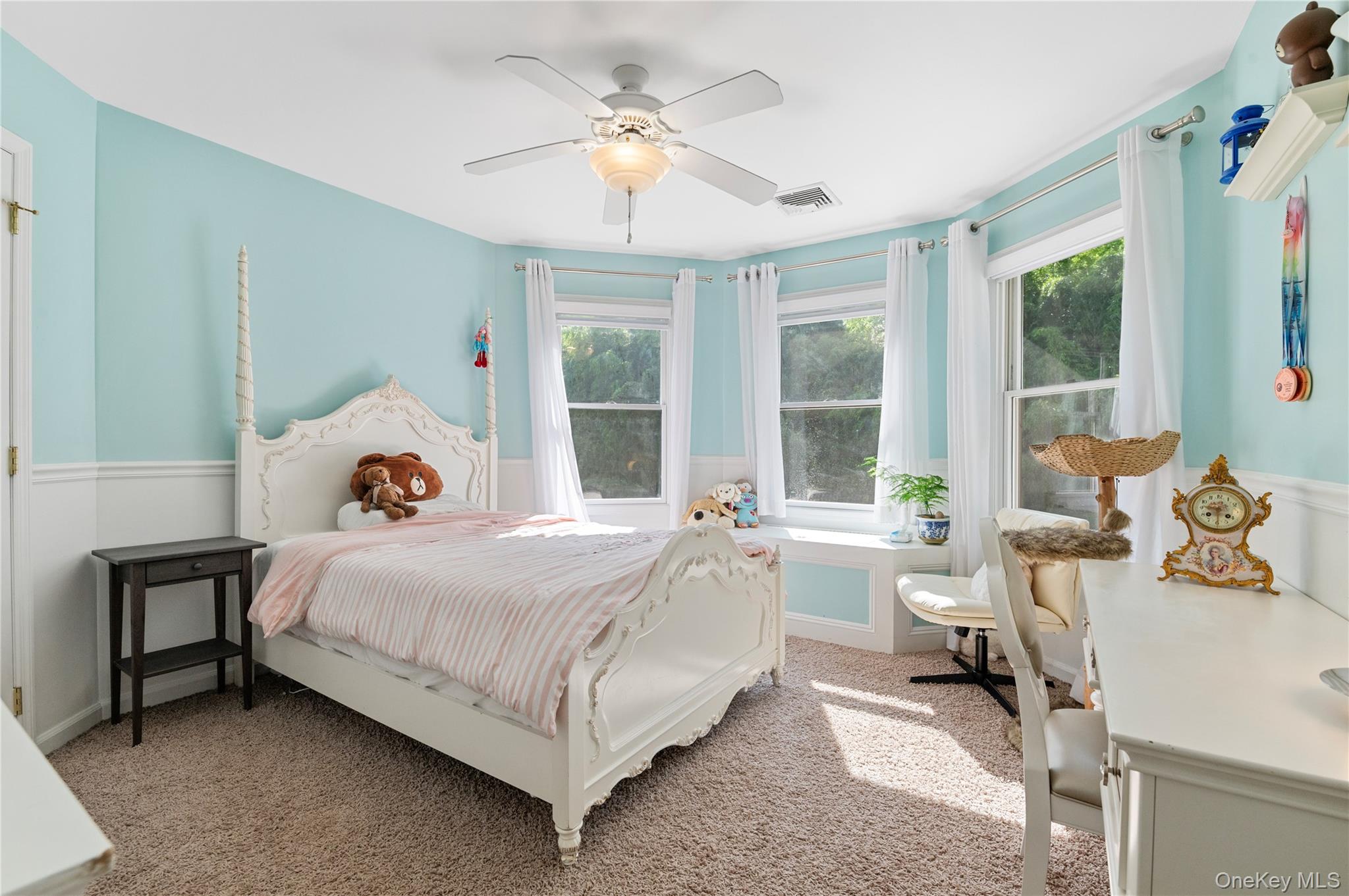 91 Bennetts Road East Setauket, NY 11733 - Photo 18 of 31 Bed Bedroom with light colored carpet, a ceiling fan, and a wainscoted wall