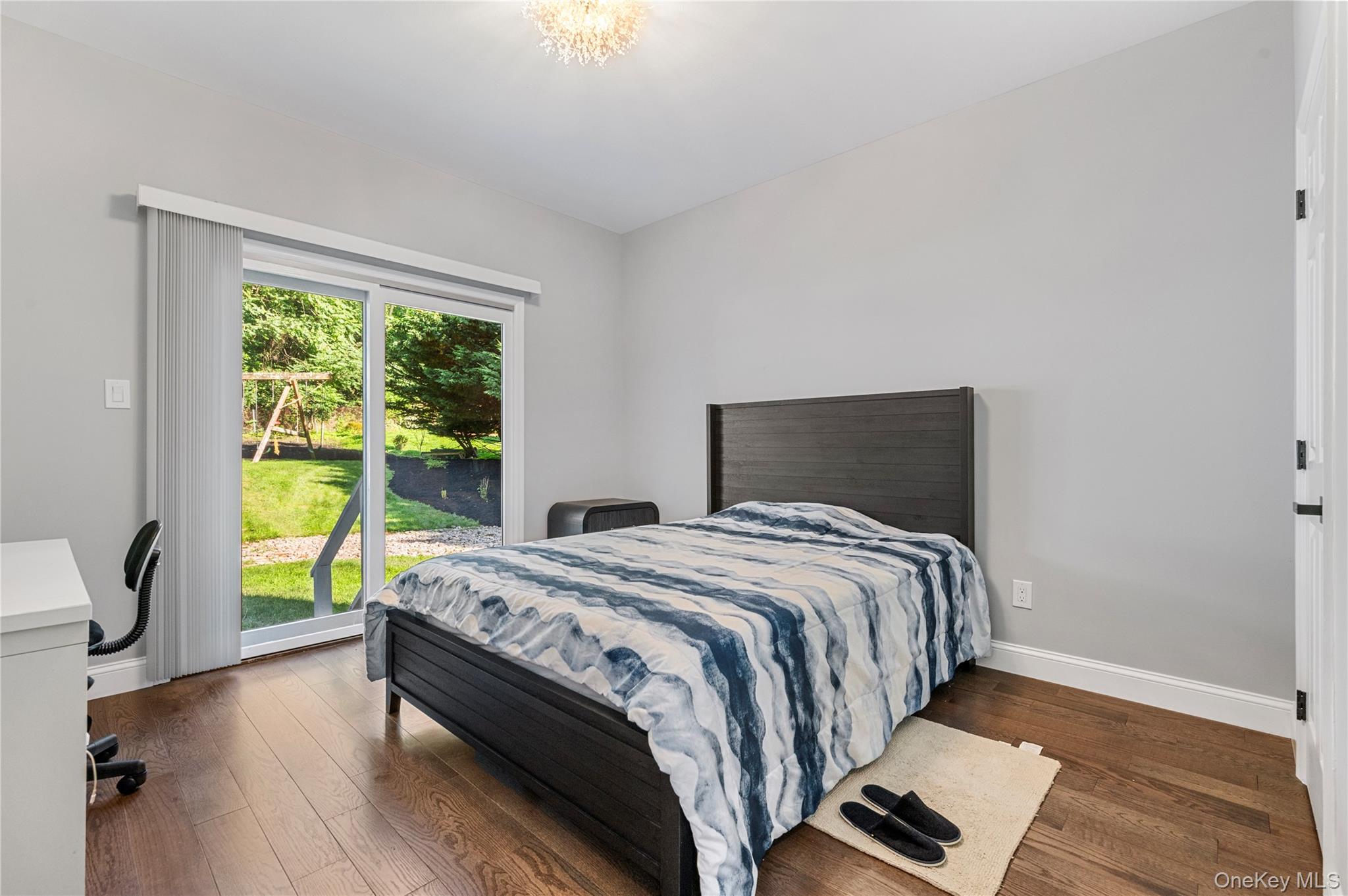 91 Bennetts Road East Setauket, NY 11733 - Photo 20 of 31 Bedroom featuring dark wood-type flooring, access to exterior, and a desk
