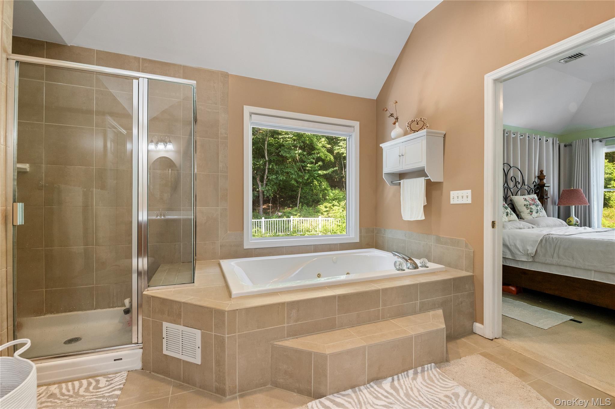 91 Bennetts Road East Setauket, NY 11733 - Photo 22 of 31 Ensuite bathroom featuring lofted ceiling, a tub with jets, a stall shower, tile patterned floors, and plenty of natural light