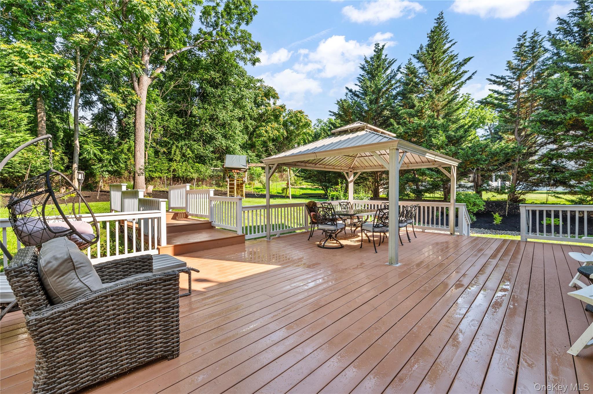 91 Bennetts Road East Setauket, NY 11733 - Photo 27 of 31 Deck featuring a gazebo, outdoor dining space, and view of wooded area