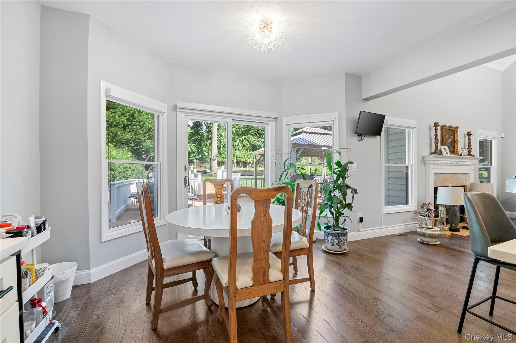 91 Bennetts Road East Setauket, NY 11733 - Photo 10 of 31 Breakfast area with plenty of natural light, a tile fireplace, and dark wood-style floors