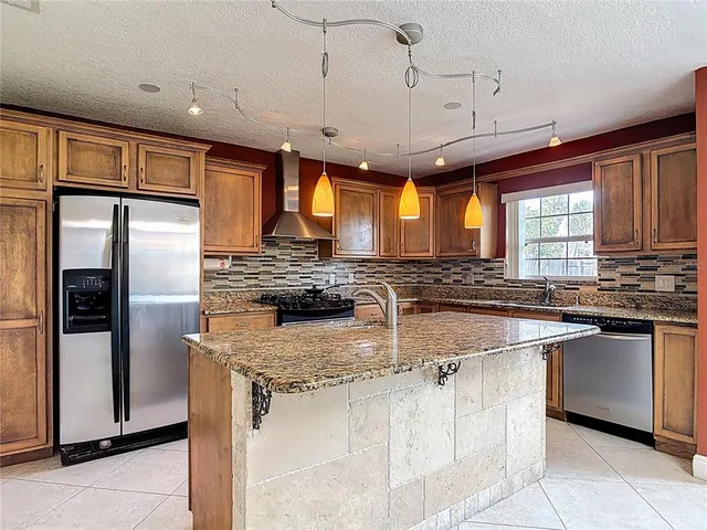 a kitchen with refrigerator a sink and microwave