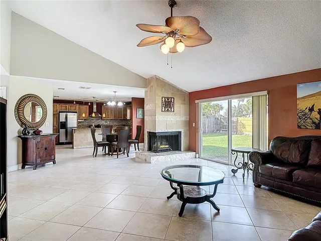 a living room with lots of furniture chandelier and a large window