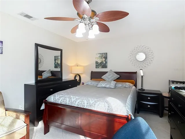 a living room with furniture and a painting on the wall