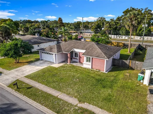 an aerial view of a house with garden space and street view