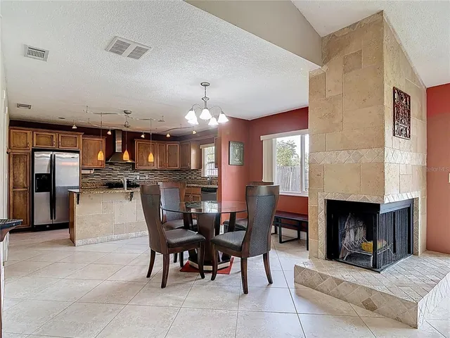 a view of a dining room with furniture and chandelier