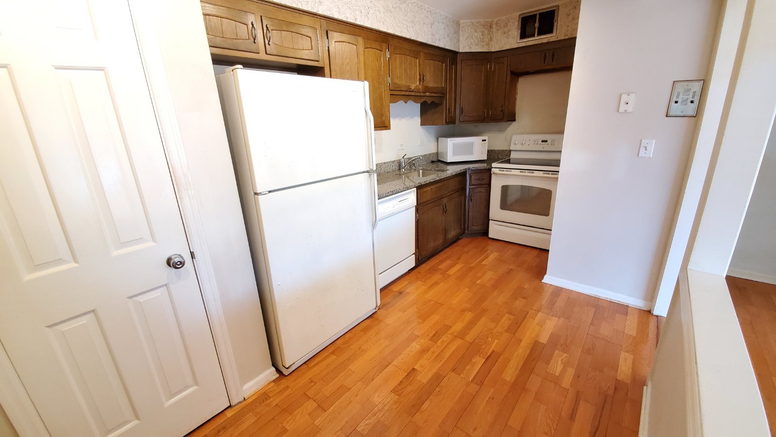 601 Ridge Road, Unit 301 Wilmette, IL 60091 - Photo 3 of 7 a kitchen with a refrigerator a stove top oven and a sink