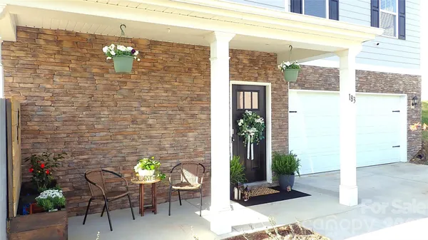 a front view of a house with outdoor seating and plants