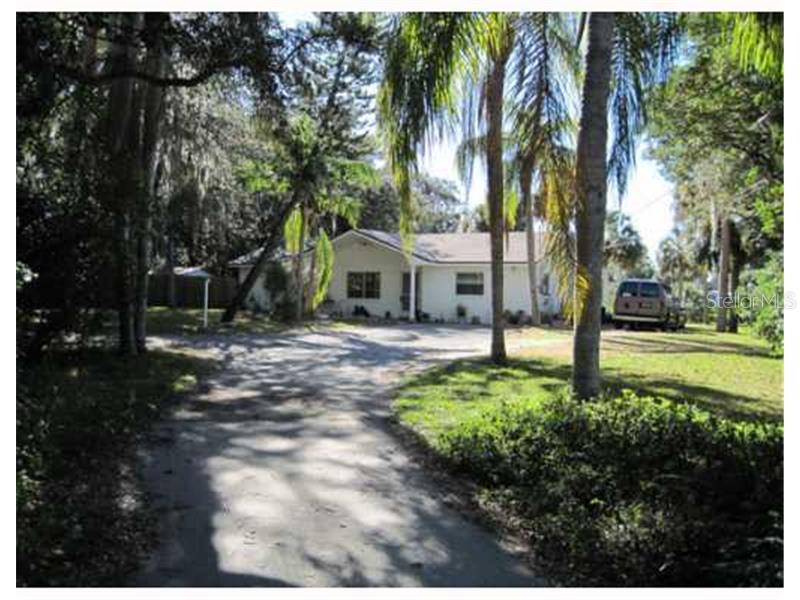 7036 Morningstar Lane New Port Richey, FL 34652 - Photo 1 of 1 a view of a house with a yard