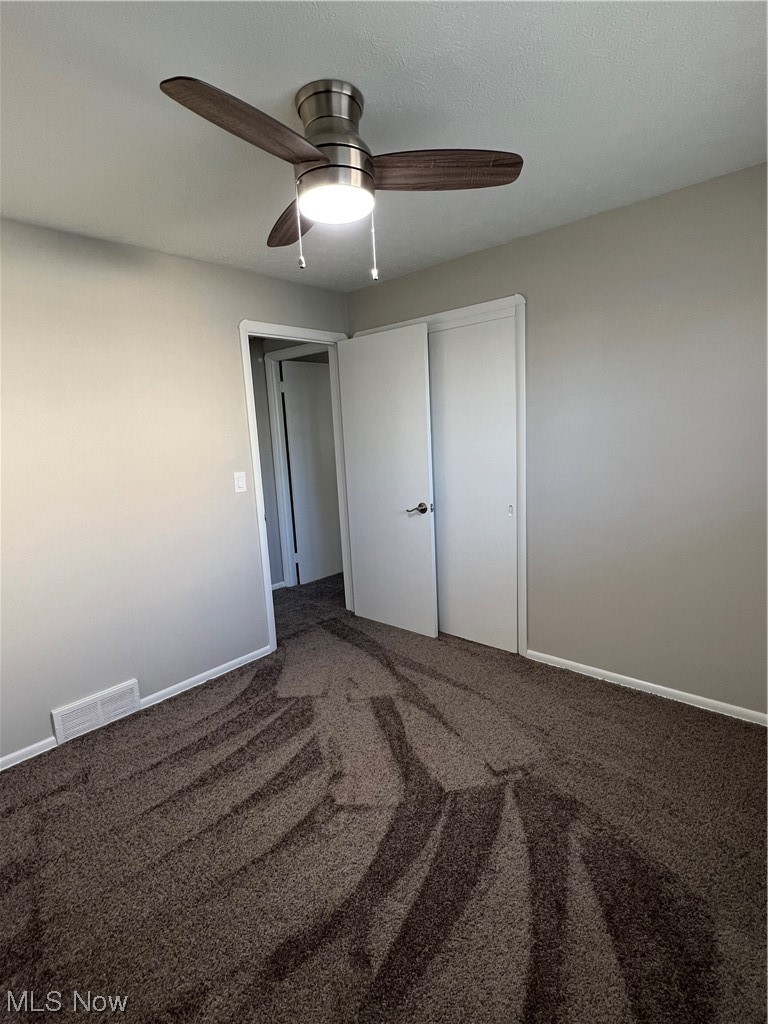 19306 Libby Road Maple Heights, OH 44137 - Photo 17 of 33 Unfurnished bedroom with ceiling fan, carpet floors, and a closet