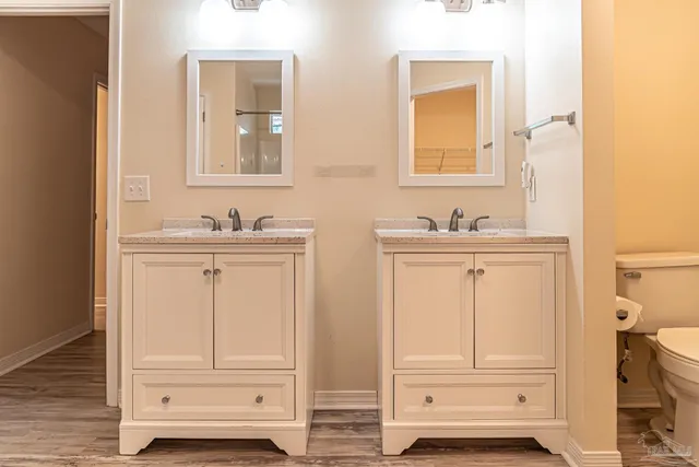 a bathroom with double sink and mirror