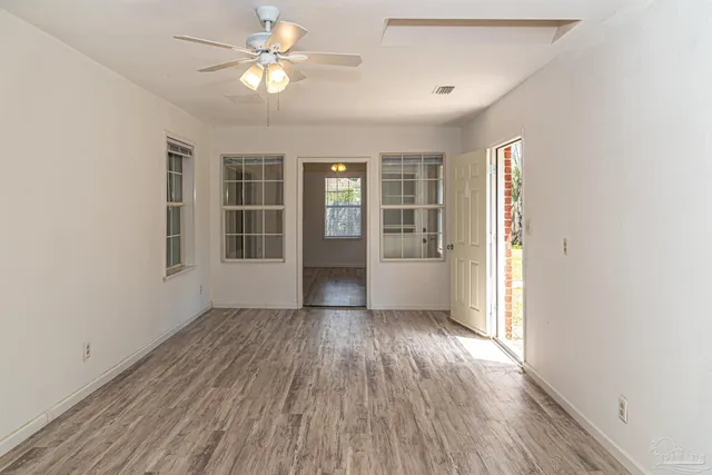 wooden floor in an empty room with a window
