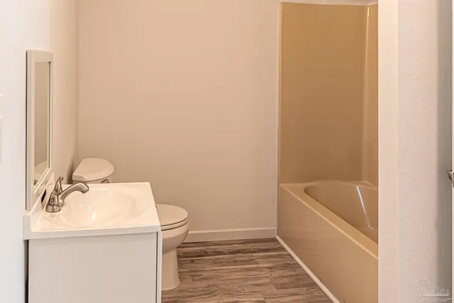 a bathroom with a sink a bathtub and toilet
