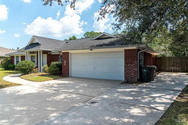 a view of a house with a yard and garage