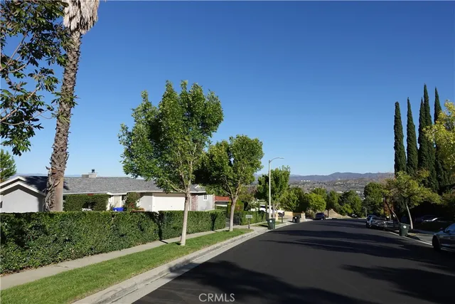 a view of a street with a building and a street sign