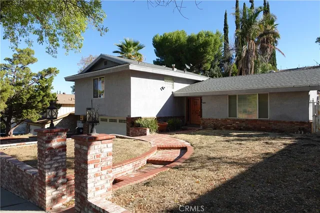 a view of a house with yard and sitting area