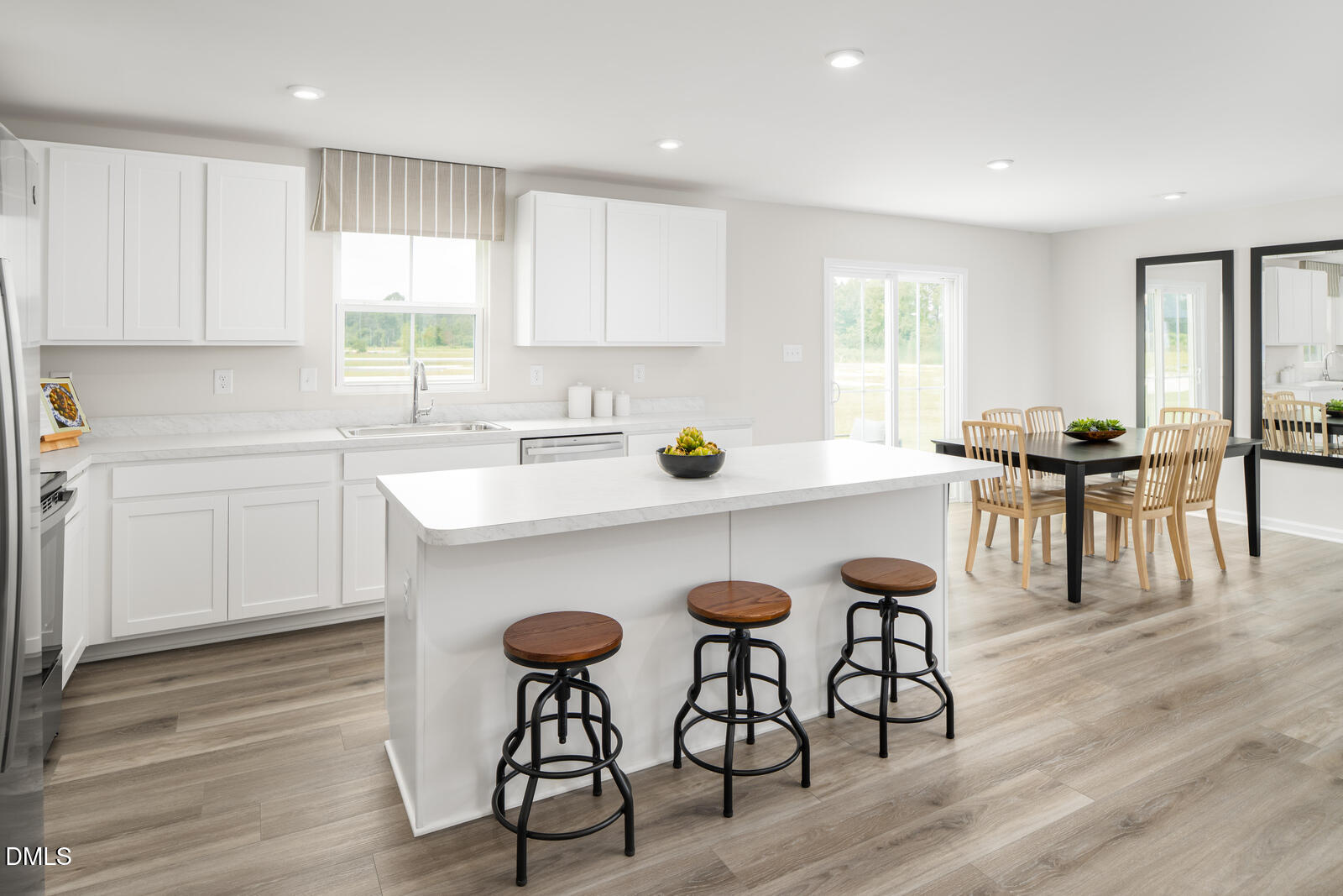 25 Better Day Way Lillington, NC 27546 - Photo 4 of 25 a kitchen with a dining table chairs and wooden floor