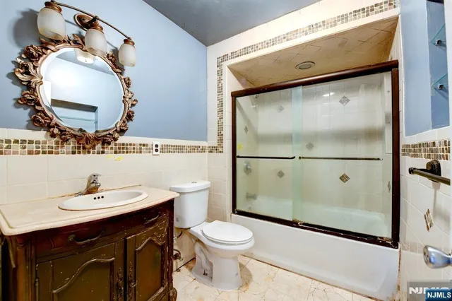 a bathroom with a toilet a sink and mirror