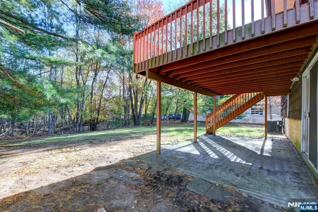 a view of a backyard with wooden fence