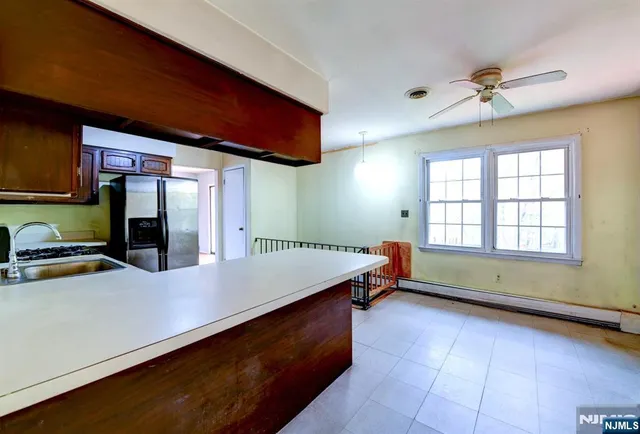 a room with pool table and a large window
