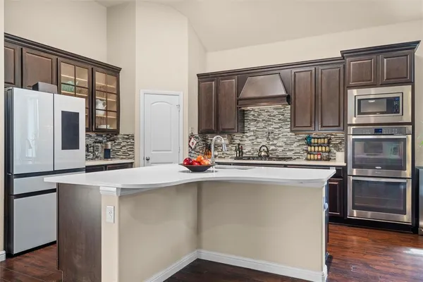 a kitchen with stainless steel appliances wooden cabinets and a counter top space