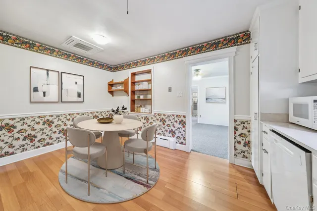 a living room with granite countertop furniture and a wooden floor