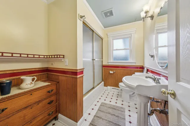 a bathroom with a sink mirror and vanity