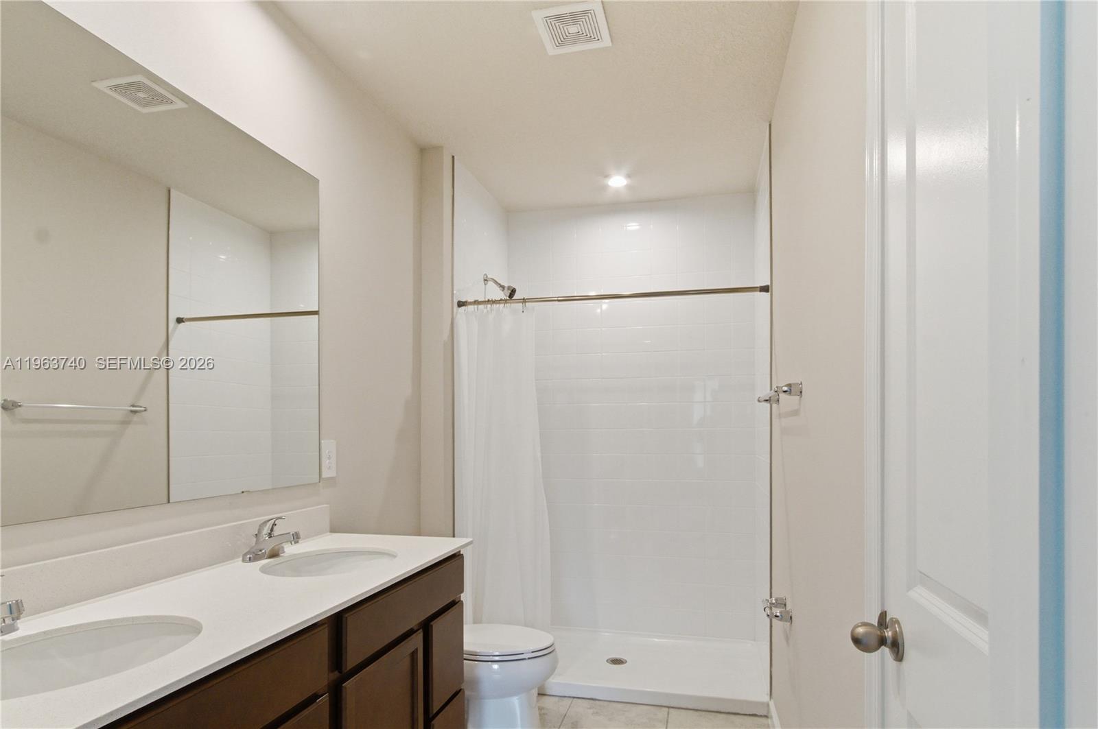 323 Raspberry Road, Unit 323 Fort Pierce, FL 34981 - Photo 14 of 29 a bathroom with a sink toilet a mirror and shower