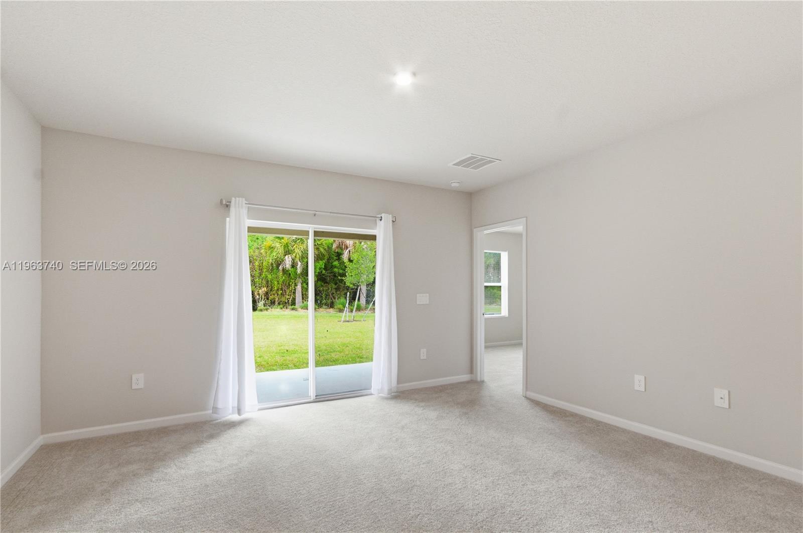 323 Raspberry Road, Unit 323 Fort Pierce, FL 34981 - Photo 9 of 29 an empty room with large windows