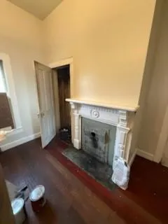 a close view of a fireplace with wooden floor