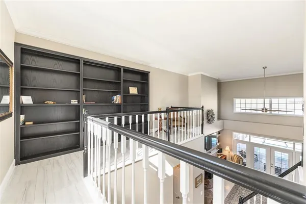 a view of a hallway with wooden floor and stairs