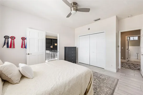 a bedroom with a large bed and a chandelier