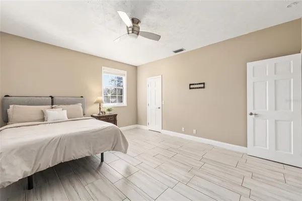 a bedroom with a bed and a chandelier
