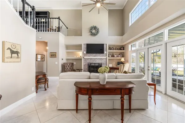 a living room with fireplace furniture and a table