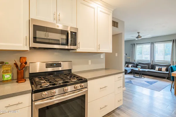 a kitchen with stainless steel appliances a stove a microwave and cabinets