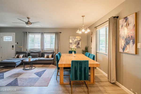 a living room with furniture a table and a chandelier