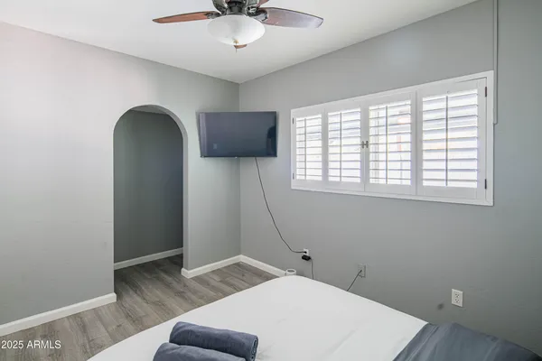 a bed room with a bed and a chair