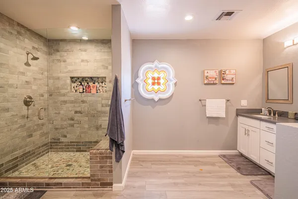 a bedroom with two beds and a chandelier