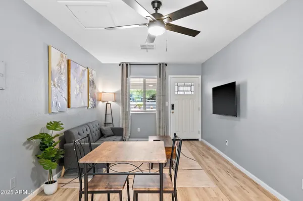 a living room with furniture a refrigerator and kitchen view