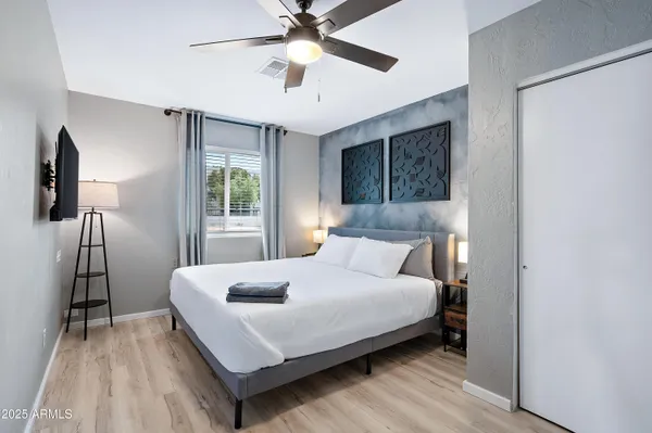 a living room with stainless steel appliances kitchen island granite countertop furniture and a flat screen tv