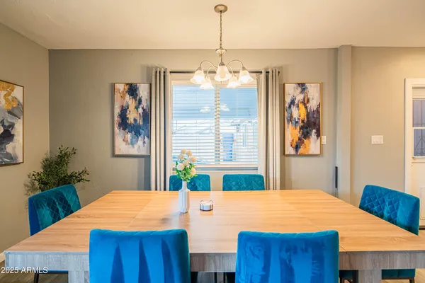 a dining room with a table chairs and chandelier