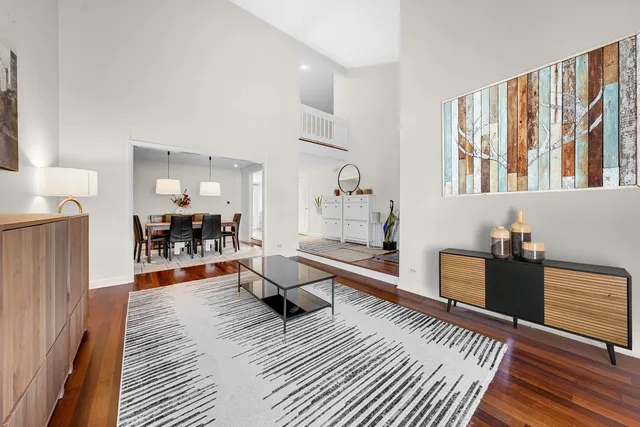 a living room with furniture windows and a wooden floor