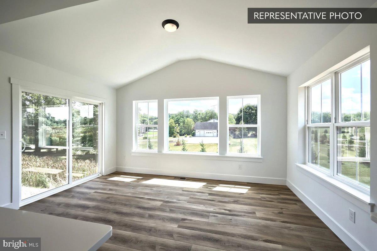 6309 Liam Drive Spring Grove, PA 17362 - Photo 6 of 20 a view of an empty room with wooden floor and a window