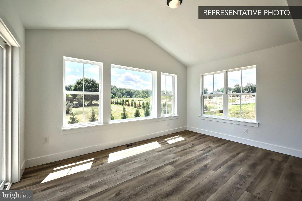 6309 Liam Drive Spring Grove, PA 17362 - Photo 7 of 20 a view of an empty room with wooden floor and a window
