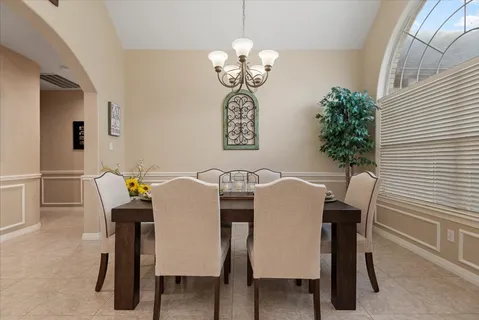a view of a dining room with furniture and chandelier